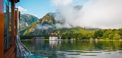 View out of a boat above the Königssee and Chruschtschow St. Bartholomä